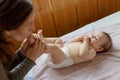 Young mother kissing the tiny feet of her baby Royalty Free Stock Photo