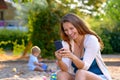 Young mother laughing at a text message