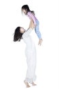 Young mother lift up her daughter