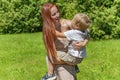 Young mother and little child kid boy son in city park.Happy family playing,having fun,holding on hands,hugging in nature against Royalty Free Stock Photo