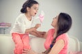 Young mother and little cute daughter playing with pinwheel Royalty Free Stock Photo