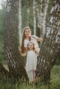 Young Mother with little daughter having fun in a meadow. Summer, nature, family, vacation. mother`s, baby`s day Royalty Free Stock Photo