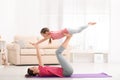 Young mother with little daughter practicing yoga