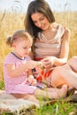 Young mother with little daughter at wheat field Royalty Free Stock Photo