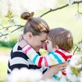 Young mother and little kid boy having fun in blooming garden Royalty Free Stock Photo