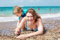 Young mother and little son having fun on beach Royalty Free Stock Photo