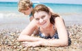 Young mother and little son having fun on beach Royalty Free Stock Photo