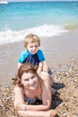 Young mother and little son having fun on beach Royalty Free Stock Photo