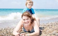 Young mother and little son having fun on beach Royalty Free Stock Photo