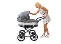 Young mother looking into baby carriage Royalty Free Stock Photo