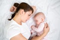 Young mother looking at her sleeping baby girl Royalty Free Stock Photo