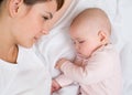 Young mother looking at her sleeping baby girl Royalty Free Stock Photo