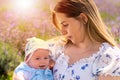 Young mother looking tenderly down at her little baby son Royalty Free Stock Photo