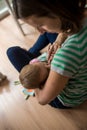 Young mother lovingly cuddling her baby girl Royalty Free Stock Photo