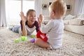 Young mother lying on floor playing with toddler son at home Royalty Free Stock Photo