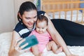 young mother is making selfie with her adorable little baby girl