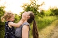 Young mother in nature holding little daughter in the arms. Royalty Free Stock Photo