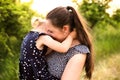 Young mother in nature holding little daughter in the arms. Royalty Free Stock Photo