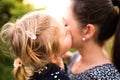 Young mother in nature holding little daughter in the arms. Royalty Free Stock Photo