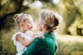 Young mother in nature holding small daughter in the arms. Royalty Free Stock Photo