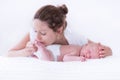 Young mother and newborn baby in white bedroom Royalty Free Stock Photo