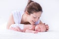 Young mother and newborn baby in white bedroom Royalty Free Stock Photo