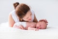 Young mother and newborn baby in white bedroom Royalty Free Stock Photo