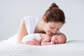 Young mother and newborn baby in white bedroom Royalty Free Stock Photo