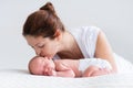 Young mother and newborn baby in white bedroom Royalty Free Stock Photo