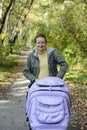 Young mother with perambulator Royalty Free Stock Photo