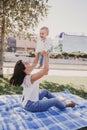 young mother playing with baby girl outdoors in a park, happy family concept. love mother daughter Royalty Free Stock Photo