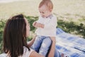 young mother playing with baby girl outdoors in a park, happy family concept. love mother daughter Royalty Free Stock Photo