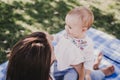 young mother playing with baby girl outdoors in a park, happy family concept. love mother daughter Royalty Free Stock Photo