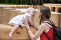 Young mother is playing with cute baby. Child smiling her mom. Outdoors Lifestyle Royalty Free Stock Photo