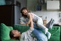 Happy mother playing having fun with kid daughter on sofa Royalty Free Stock Photo