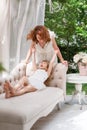 Young mother playing and having fun with her little daughter in green summer park. Family happiness, childhood concept. Royalty Free Stock Photo