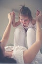 Young mother playing with her baby girl in bed. Royalty Free Stock Photo