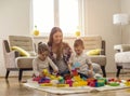 Young mother playing with her children at home Royalty Free Stock Photo