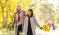 Young mother playing with her daughter in autumn park Royalty Free Stock Photo