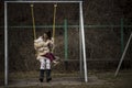 Young mother playing on a swing with her child Royalty Free Stock Photo