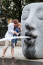 Young mother playing with toddler boy with water of fountain Royalty Free Stock Photo