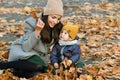 Young mother plays with a small child in an autumn park Royalty Free Stock Photo