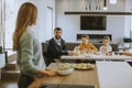 Young mother preparing breakfast for her family in the kitchen Royalty Free Stock Photo