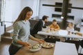 Young mother preparing breakfast for her family in the kitchen Royalty Free Stock Photo