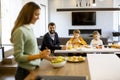 Young mother preparing breakfast for her family in the kitchen Royalty Free Stock Photo