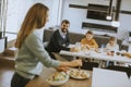 Young mother preparing breakfast for her family in the kitchen Royalty Free Stock Photo