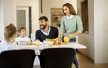 Young mother preparing breakfast for her family in the kitchen Royalty Free Stock Photo