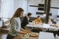 Young mother preparing breakfast for her family in the kitchen Royalty Free Stock Photo