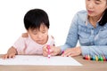 Young mother or preschool teacher teaching little girl to draw Royalty Free Stock Photo