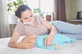 Young mother in protective face mask with newborn cute infant baby breastfeeds him with breast milk Royalty Free Stock Photo